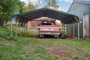 Metal carports for RVs with vertical roof and side panels in a residential setting