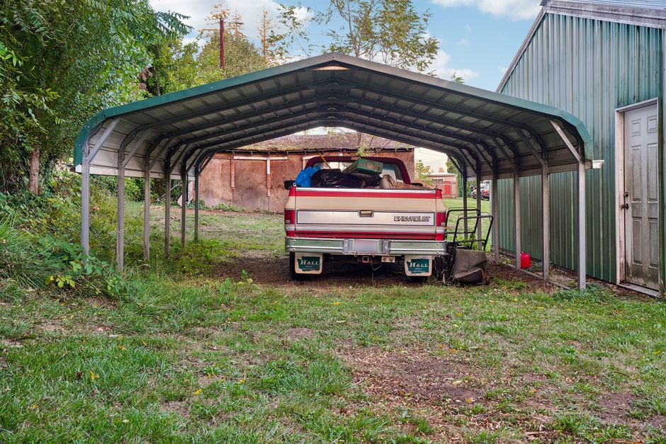 20x20 metal carport with two cars parked underneath 20x20 metal carports