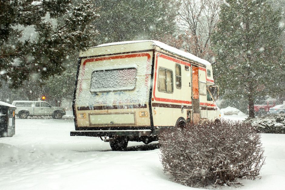 metal rv cover protecting a recreational vehicle in a sunny yard