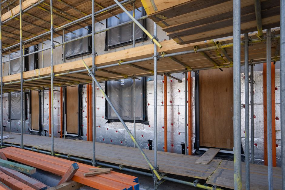Metal building with roof insulation being installed