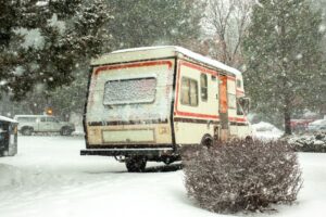A durable rv cover metal structure sheltering a recreational vehicle beside a home.