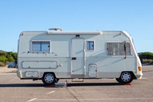 RV cover ADCO fabric cover fitted over a travel trailer parked at a western mountain property