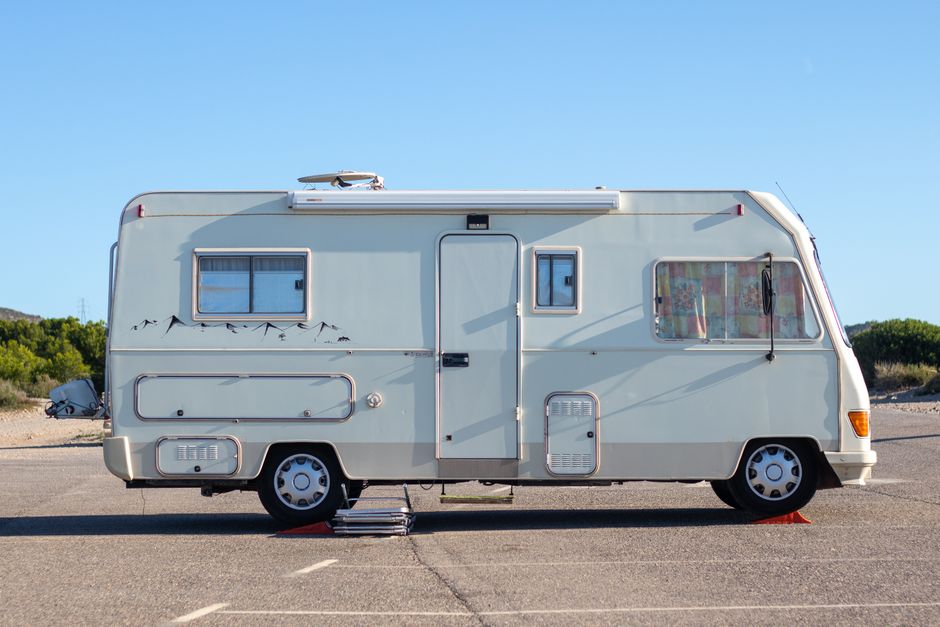 RV cover ADCO fabric cover fitted over a travel trailer parked at a western mountain property