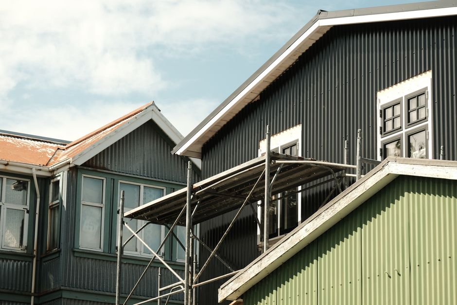 Finished metal building as a house with a standing seam roof and attached shop bay metal buildings as houses